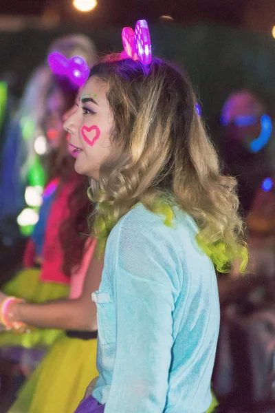 Colorful happy woman at the Color Run Night Edition in Stockholm