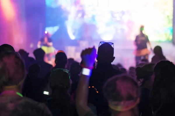 Silhouettes of happy people infront of the stage at the Color Ru — Stock Photo, Image