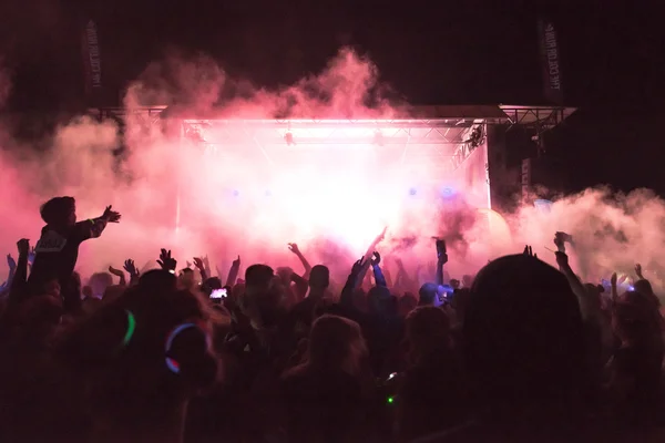 Bright colorful stage with crowd in front at the Color Run Night