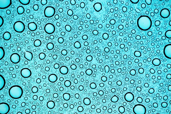 Fondo abstracto con burbujas de agua en un escudo de vidrio — Foto de Stock