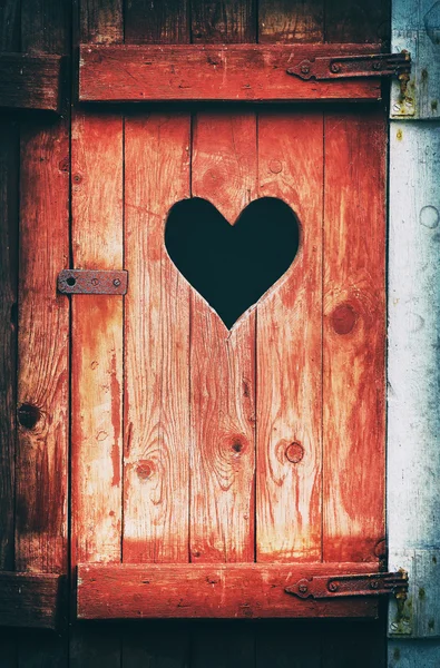 Old vintage toilet door with a heart shaped hole — Stock Photo, Image