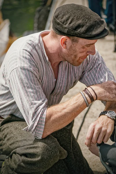 Exhausted rower in vintage clothes from one of the first postal