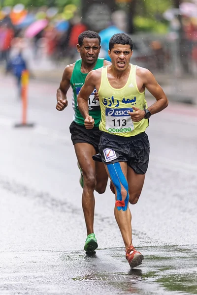 Mohammad Jafar Moradi and Abdulahakim Chocke in the rain at ASIC — Stock Photo, Image