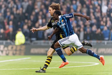 Two players chasing the ball in the soccer game DIF vs AIK at Te