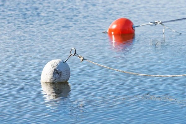 White marker bouy in foreground and a red one in the back — Φωτογραφία Αρχείου