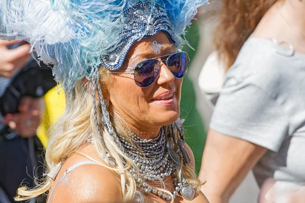 Happy smiling woman with feathers at the Pride parade — Stock Photo, Image
