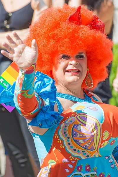 Colorful crossdresser with a big red wig at the Pride parade — Stok fotoğraf