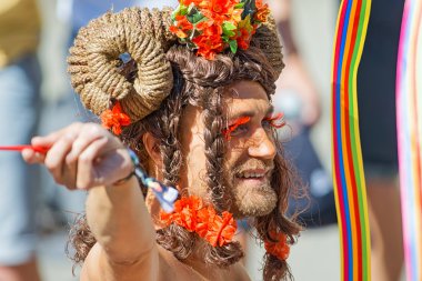 Man with beard and long hair and red eyelashes at the Pride para