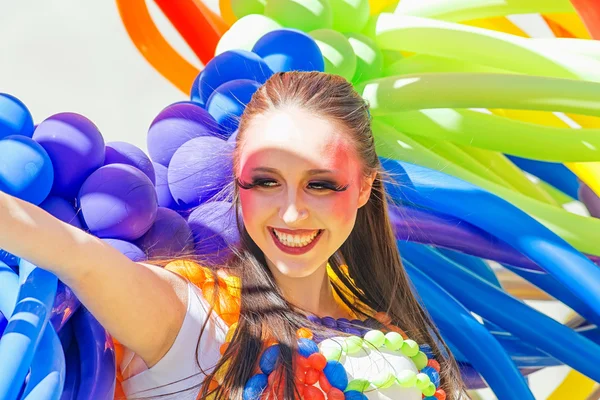 Smiling girl with colorful baloons at the Pride parade — Stok fotoğraf