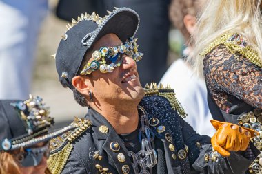 Man in black with nails and buttons at the Pride parade