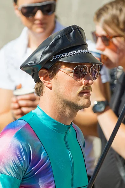 Man in leather hat and lycra dress at the Pride parade — Stock Photo, Image