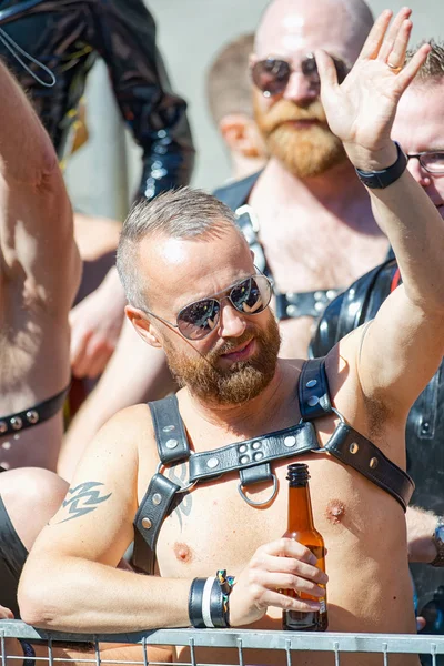 Men in leather at a floater waving to the crowd at the Pride par — Stock Photo, Image