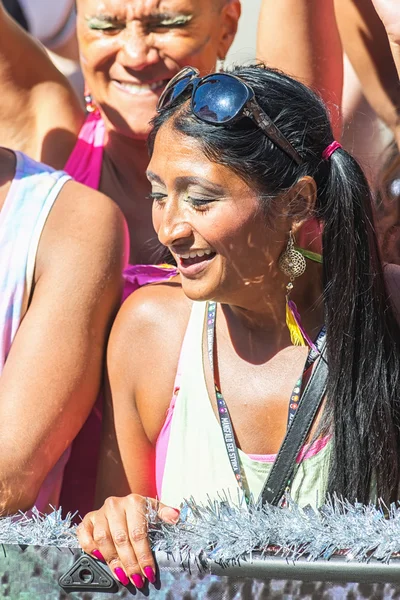 Woman in black hair and red nails on a floater at the Pride para — Stock Photo, Image