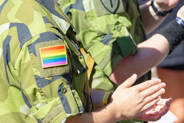 Swedish military with rainbow insignia on camoflage sleeve at th