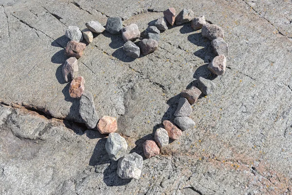 Stones in a heart shaped love sign — Stock Photo, Image