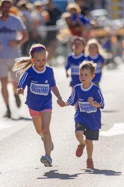 Sister holding her litttle brothers hand during the Minimil for 