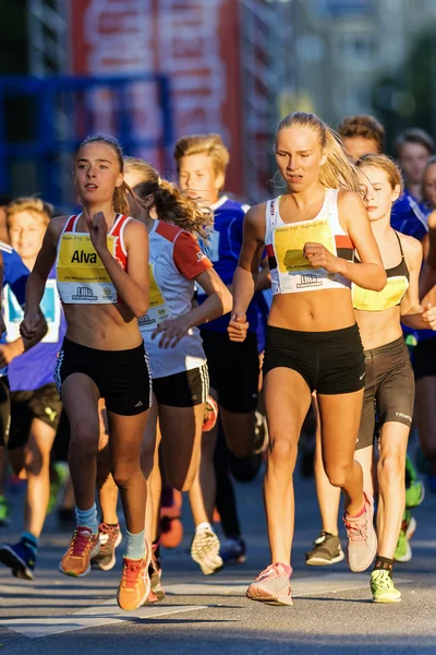 Young girls running at midnihtrun or Lilla Midnattsloppet for ru — Stockfoto