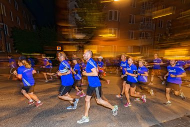 Sideview of a group of runners with motion blur on the streets o