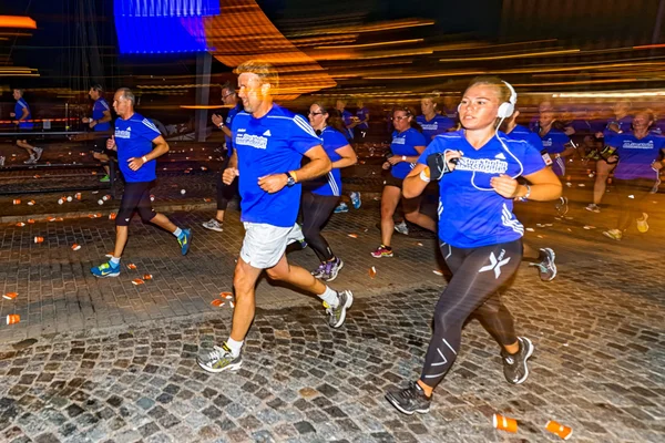 Woman runner with headphones motion blur on the streets of Soder — Stok fotoğraf