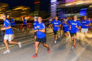 Group of runners with colorful motion blur on the streets of Sod