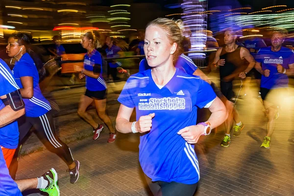 Closeup of female runner in colorful motion blur on the streets — Stock Photo, Image