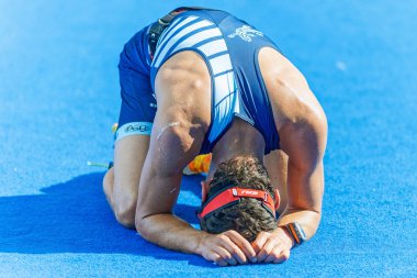 Exhausted triathlete at the finish area at the ITU World Triathl