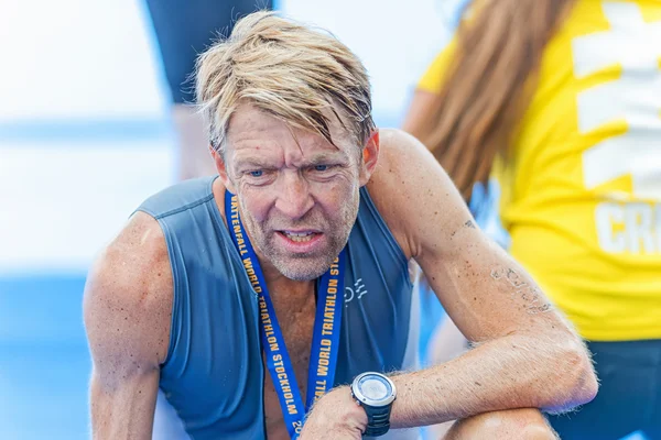 Exhausted male triathlete at the finish area at the ITU World Tr — ストック写真