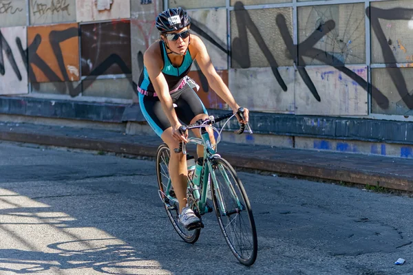 Female triathlete on a bike in a curve at Slussen in the ITU Wor — Stok fotoğraf