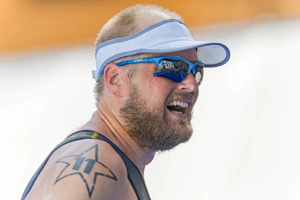 Male triathlete with the finish area reflected in his sun glasse — ストック写真
