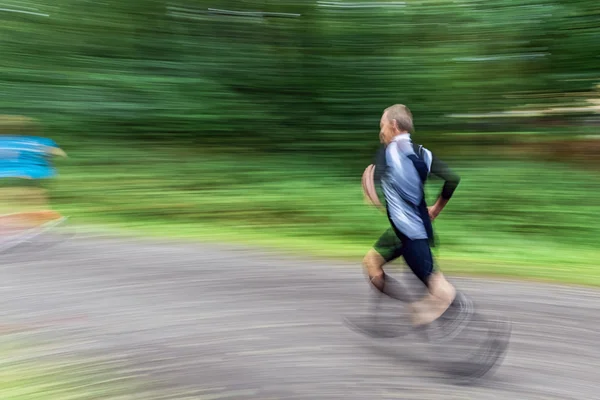 Male runner in motion blur in forest at the event 5K EASD Run Wa — Stock Photo, Image