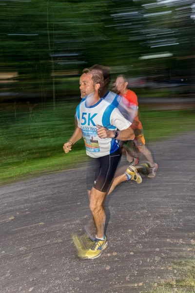 Male runner in motion blur in forest at the event 5K EASD Run Wa — ストック写真