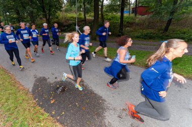 Group of runners in motion blur at forest pathway at the event 5