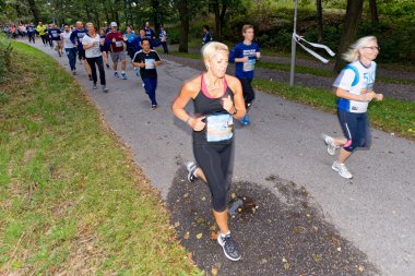 Group of runners in motion blur at forest pathway at the event 5