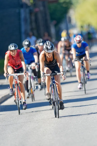 Group of female triathletes on bicycle on the road at the ITU Wo — Stok fotoğraf