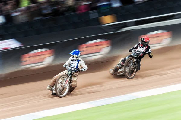 Tomas H Jonasson and Tai Woffinden into a curve with motion blur — стокове фото