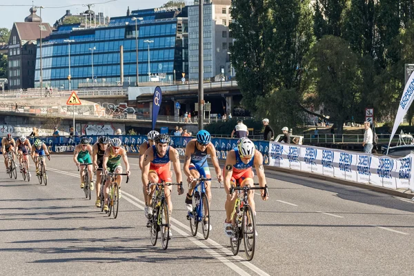 Group of male triathletes on bicycles at Slussen in the Men's IT — стокове фото