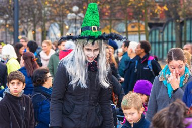Witch is leader of children games at Halloween parade Shockholm 