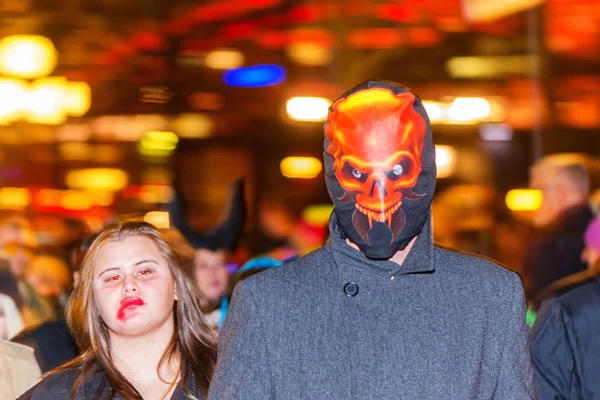 Люди с ярким светом на заднем плане на параде Хэллоуина — стоковое фото