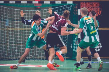 Intense physical play at the line in the Handball game between H