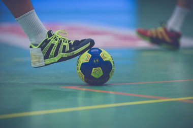 Players shoe with hand glue on a ball at the Handball game betwe