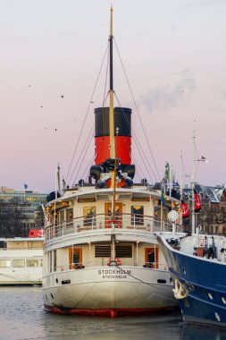 Steam ship Stockholm from the rear during a cold winter morning clipart