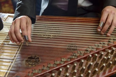 Fingers Playing Arabian Qanon Musical Instrument clipart