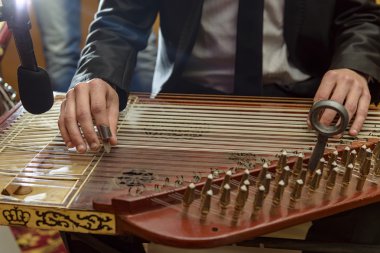 Male Hands Playing Arabian Qanon Musical Instrument clipart