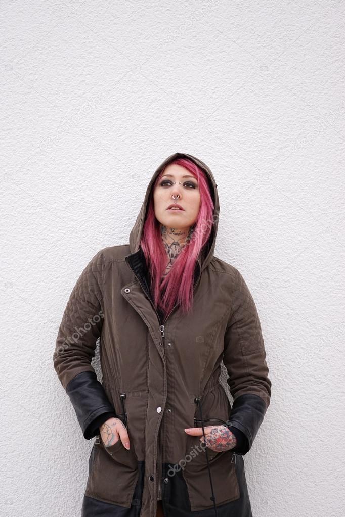 woman with pink hair piercings and tattoos