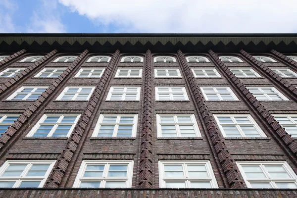 Brick building facade with endless rows of windows — Stock Photo, Image