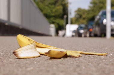 discarded banana skin on pavement clipart