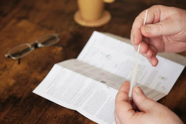 Person using corona virus covid-19 rapid antigen self test kit at home — Stock Photo, Image