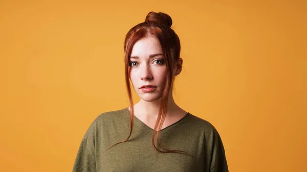 Portrait of pretty young woman with red hair bun and curtain bangs — Stock Photo, Image