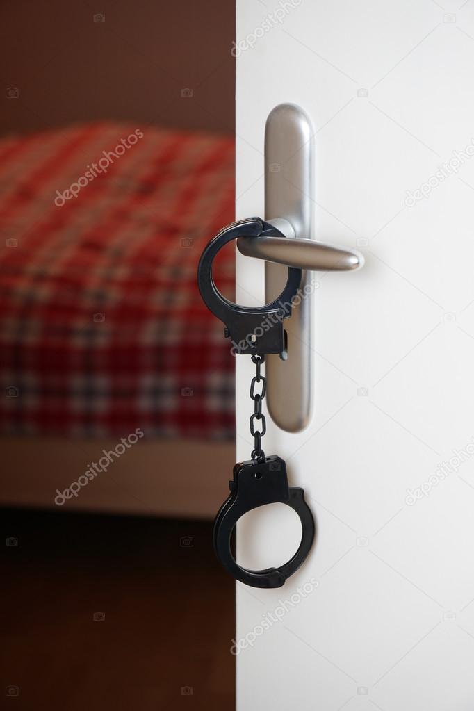 handcuffs on bedroom door handle