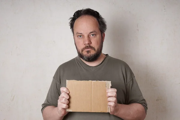 Scruffy man holding sign — Stock Photo, Image